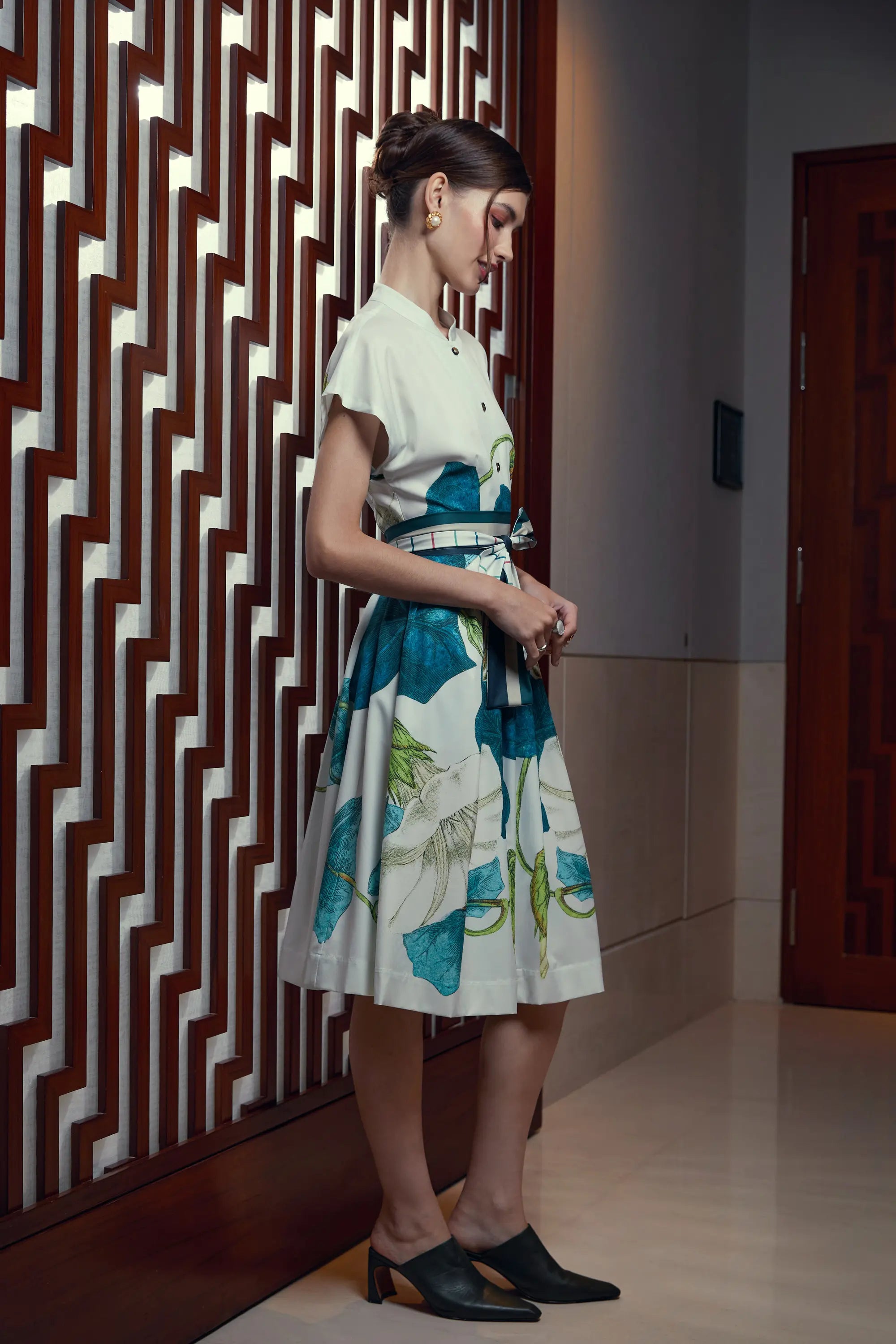 Woman wearing Arrayed Bindweed fit-and-flare dress with Chinese collar, side view