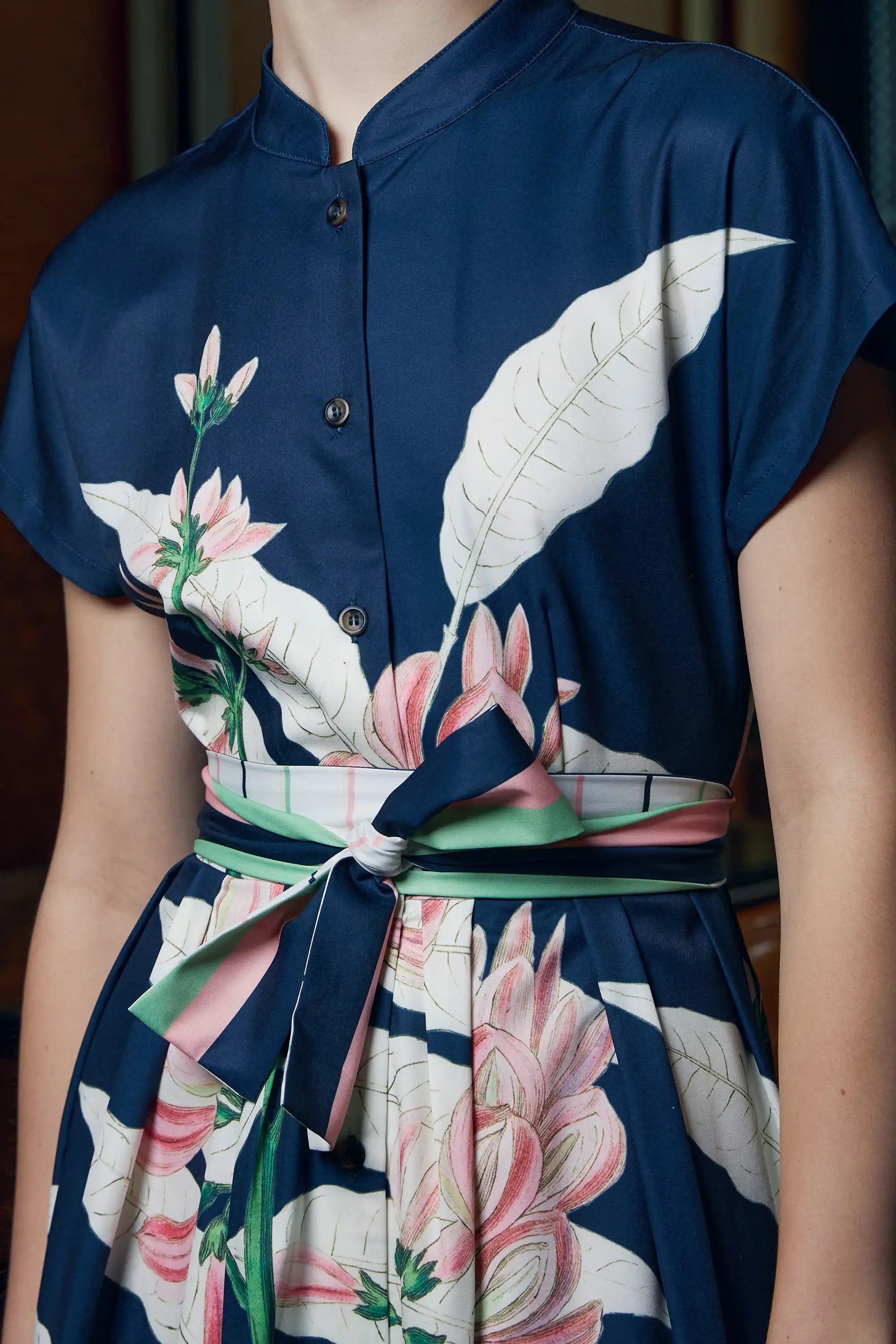 Close-up of Arrayed navy Geoffroya Inermis print dress with micro chinese collar and waist sash