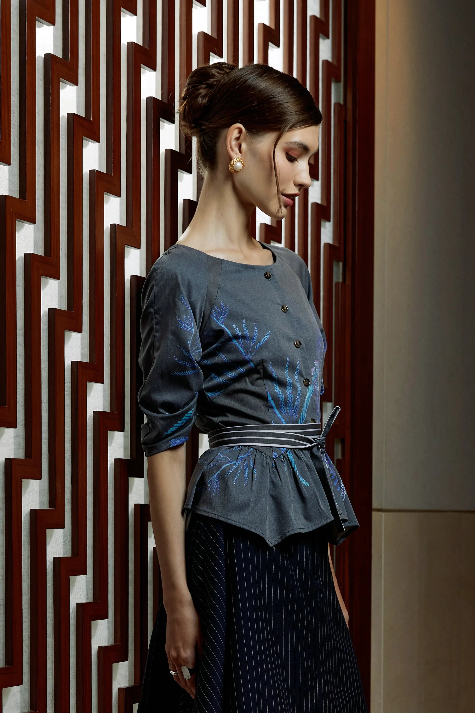 Woman wearing Arrayed Acacia Catechu fan contour top with fan sleeves, side view