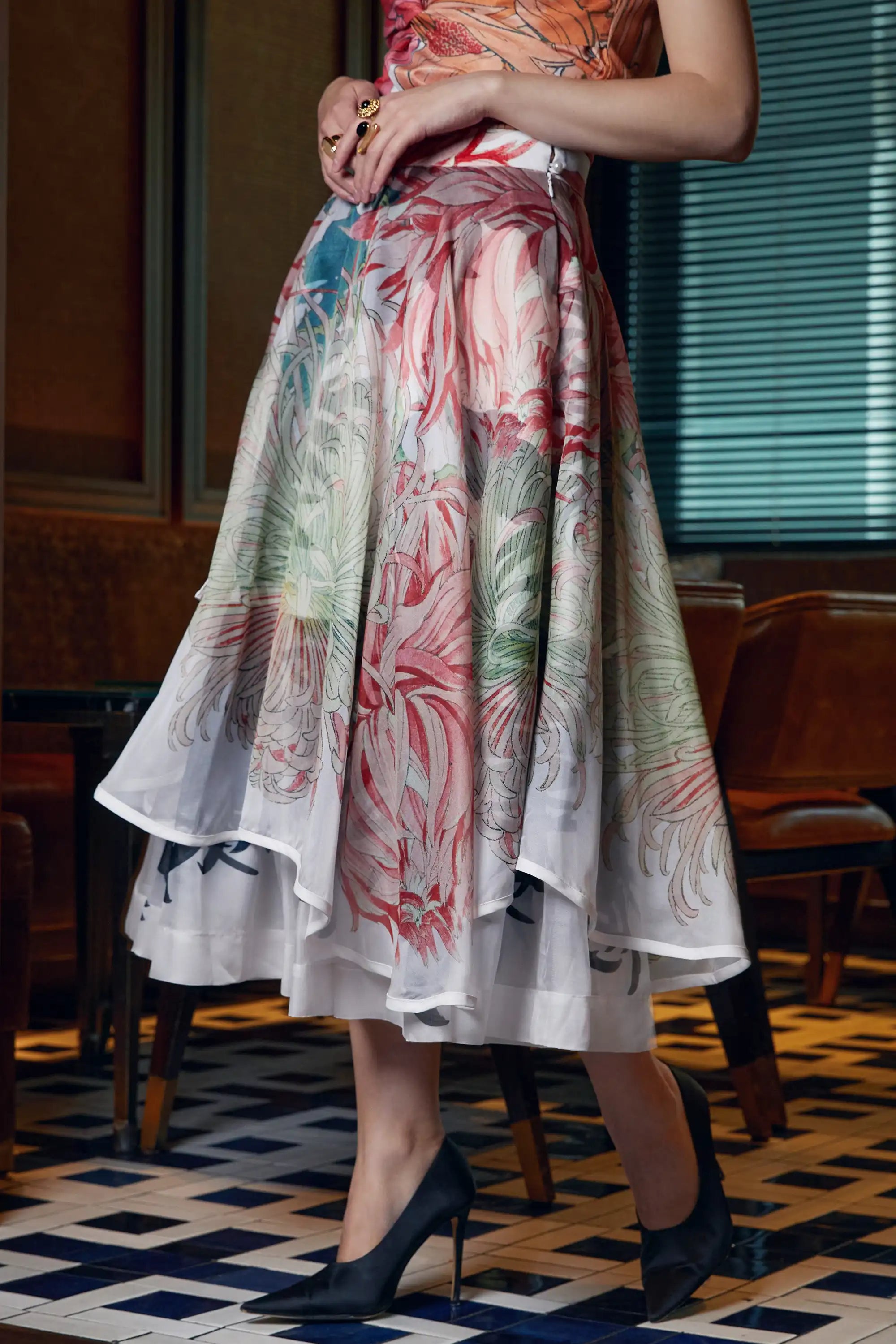 Side view of Arrayed white Chrysanthemum print organza piping skirt