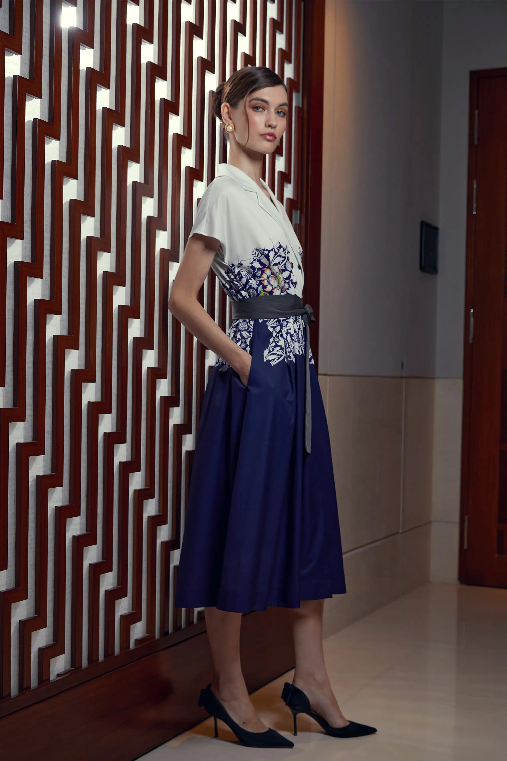 Woman wearing Arrayed Peony trench dress with dolman sleeves, side view