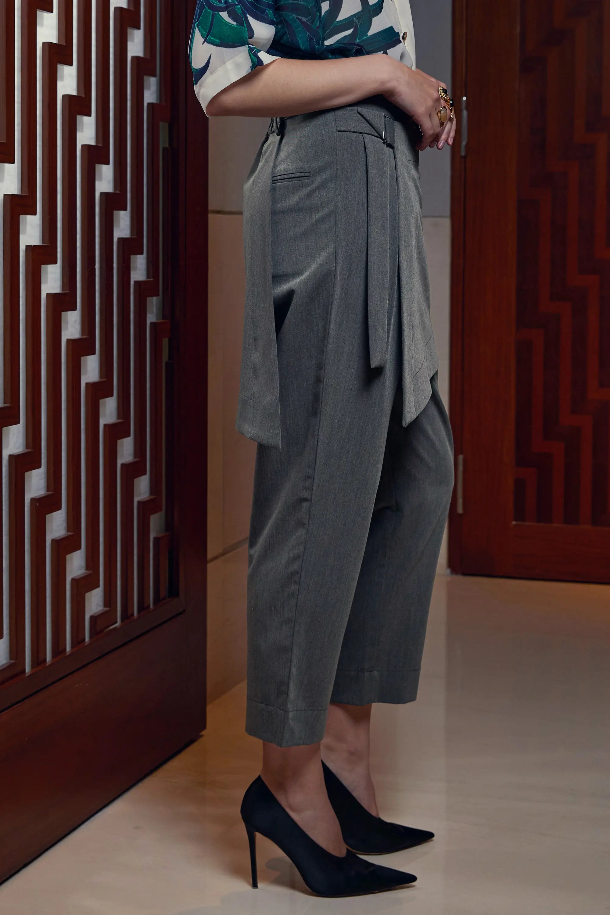 Woman wearing Arrayed wrap trousers with asymmetric front panel, side view