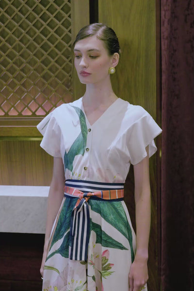 Close-up video of Arrayed ivory Almond print midi dress with sash and pockets