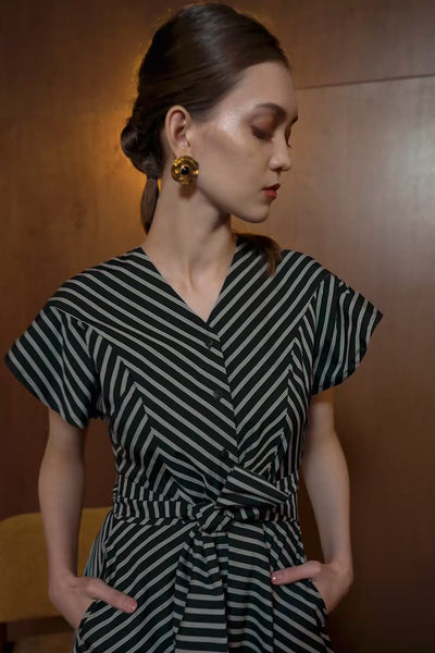 Model in Bluebell Dress with black diagonal stripes — V-neck wrap silhouette with short sleeves and belted waist
