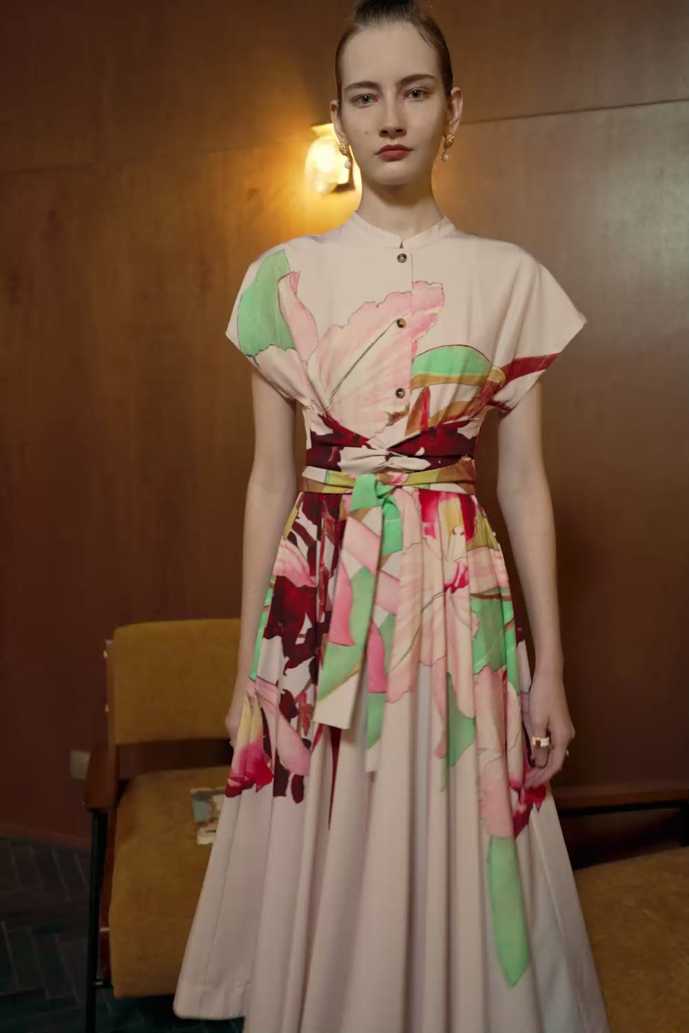 Model in Interlaced Sash Dress with Cattleya & Oncidium print — pleated full skirt and wrapped waist in painterly florals