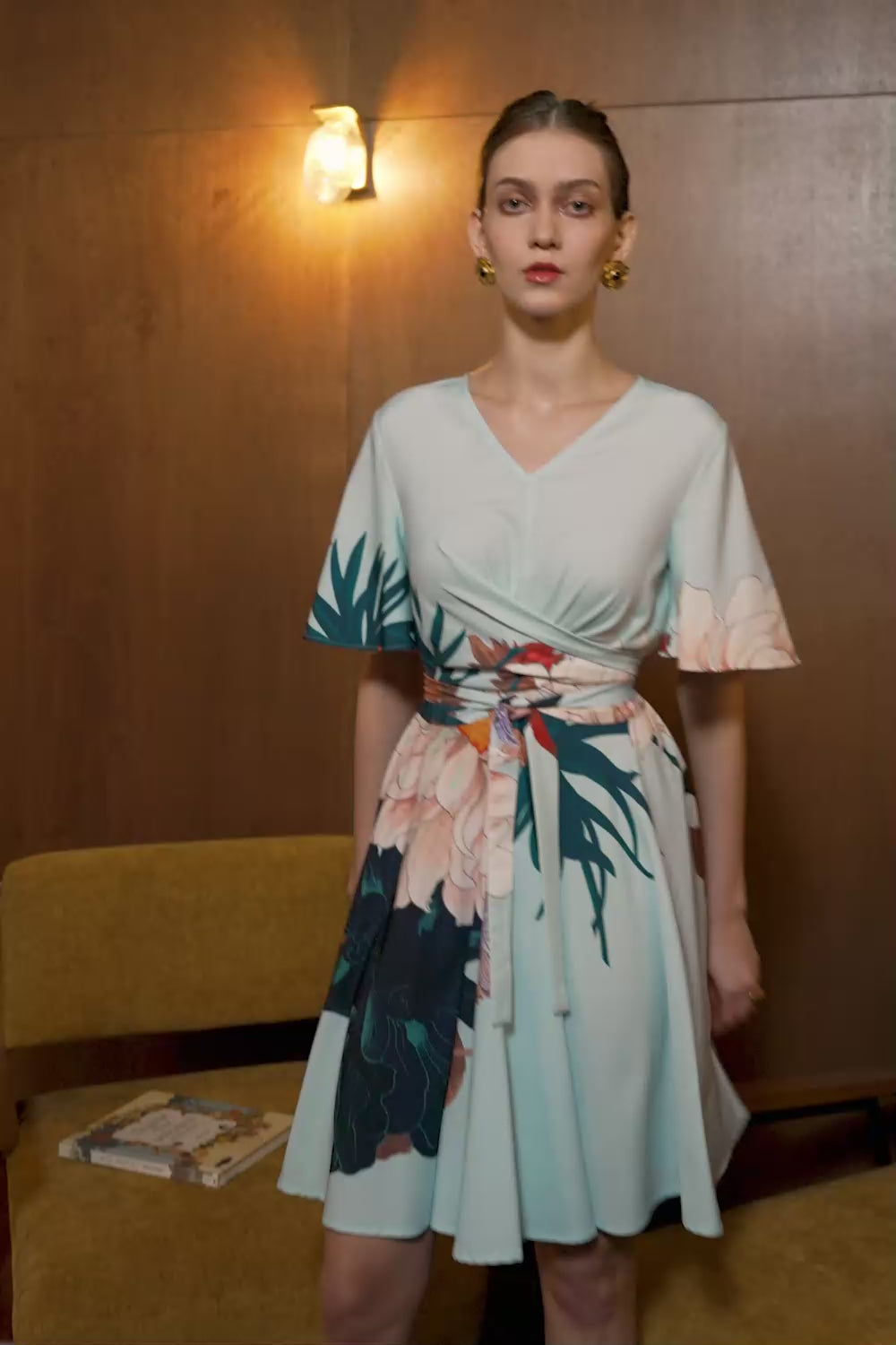 Model in Dahlia print Criss Cross Flutter Dress — V-neck silhouette with flutter sleeves and wrap waist detail in motion