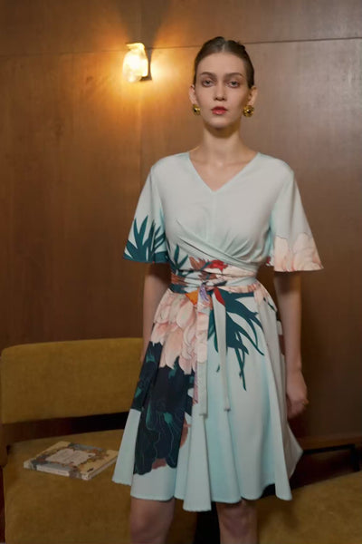 Model in Dahlia print Criss Cross Flutter Dress — V-neck silhouette with flutter sleeves and wrap waist detail in motion