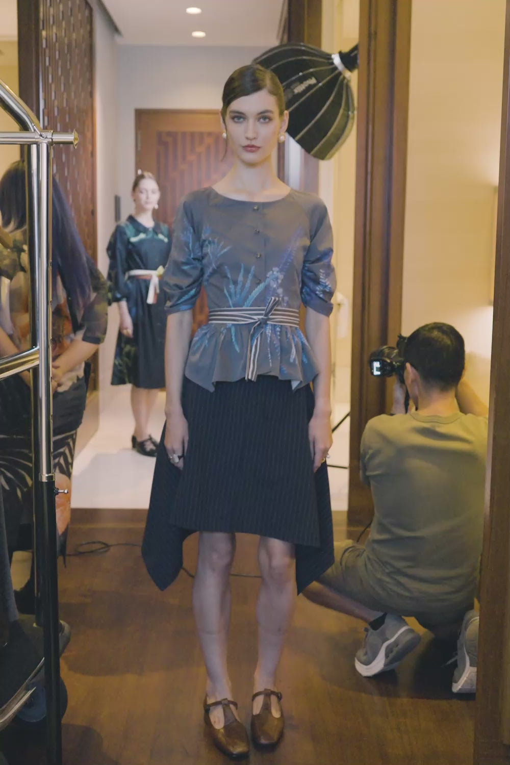 Video of Arrayed Acacia Catechu fan contour top with navy pinstripe handkerchief skirt