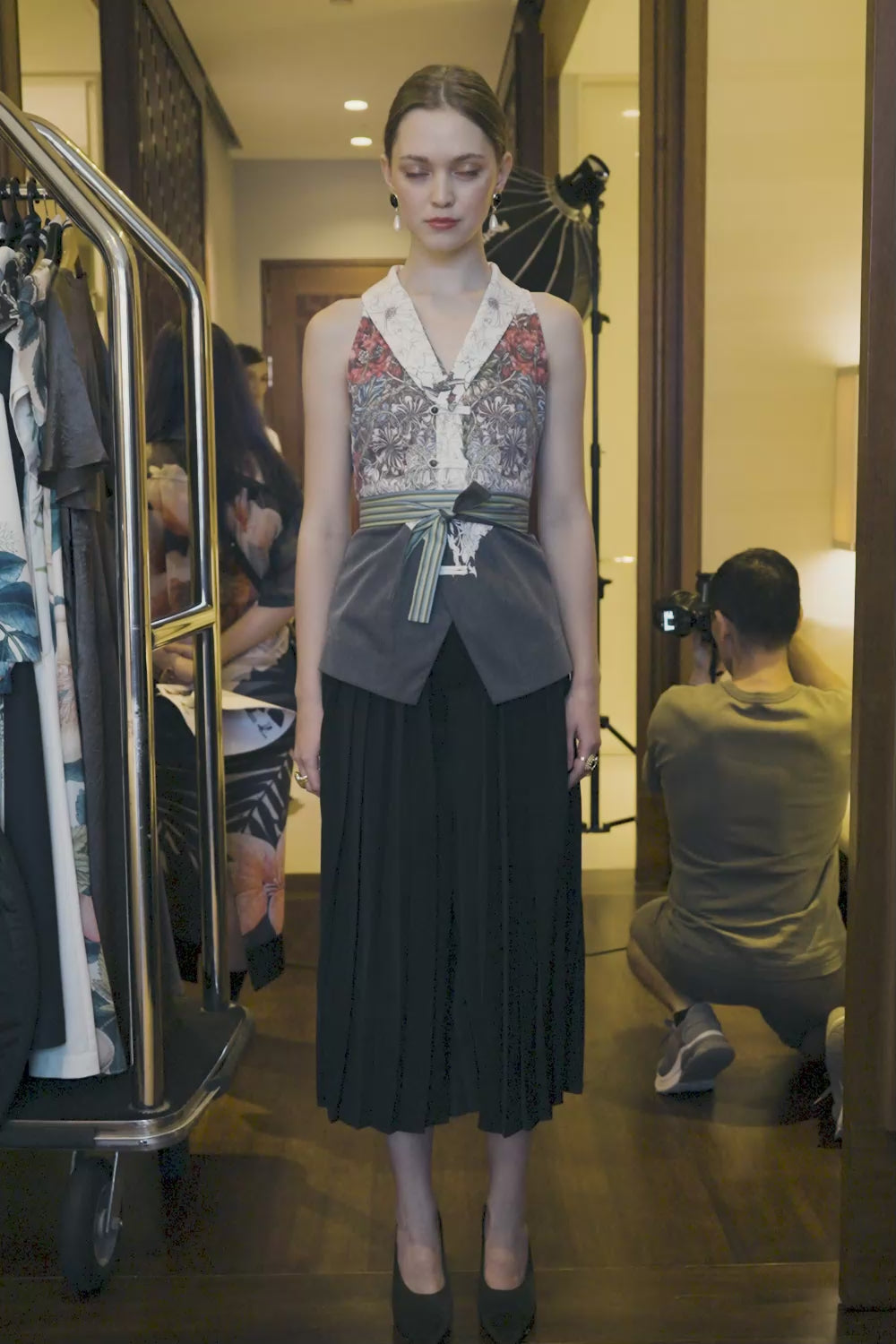 Video of Arrayed Honeysuckle print shawl collar top with black pleated skirt trousers