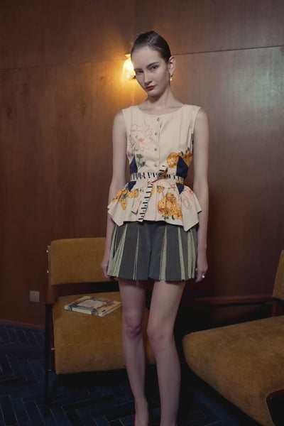 Model in Calceolaria print contour top and striped godet shorts — structured silhouette with soft flare in motion